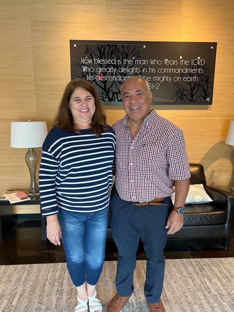 Couple smiling at the closing office, celebrating their new home